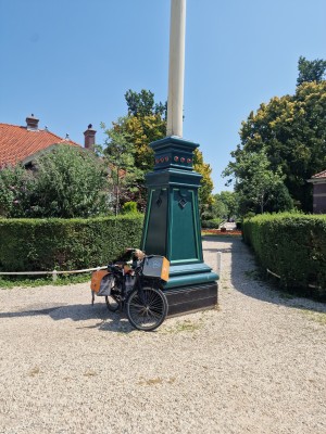 
                            <b>Fiets geparkeerd tegen groene sokkel met vlaggenmast en oranje PostNL fietstassen.</b><br>
                                                        <b>ISO:</b> 50 | <b>Sluitertijd:</b> 1/1337 | <b>Diafragma:</b> f/1.8 | <b>Datum:</b> 2025-07-02

                        
